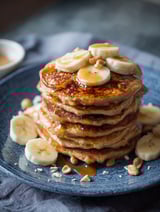 Banana pancakes with nuts on a plate.
